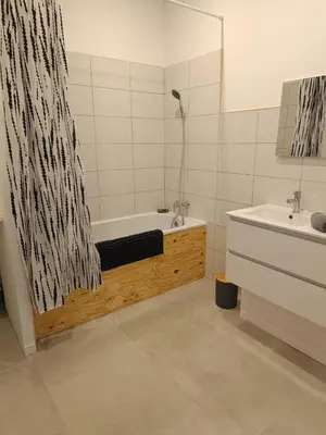 a bathroom with a bath tub and a sink at La Villa des Trois in Cavaillon