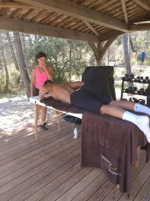 a woman standing next to a man laying on a table at Domaine la Garenne in Saint-Marc-Jaumegarde