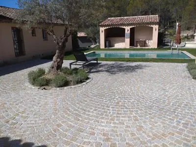 a house with a tree and a swimming pool at Domaine la Garenne in Saint-Marc-Jaumegarde