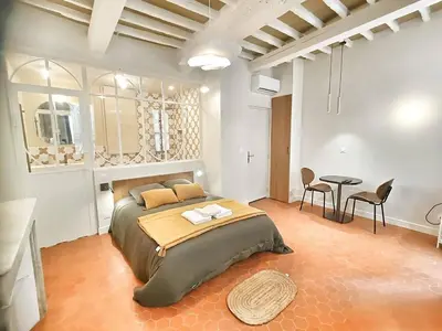 a living room with a couch and a table at Le Mignet by Rentalaix in Aix-en-Provence