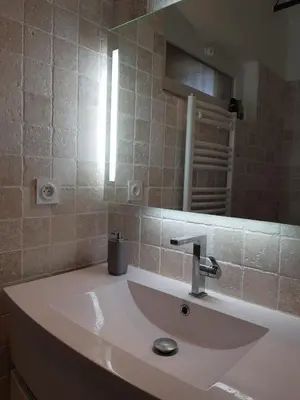a bathroom with a sink and a mirror at Villa Soleil Piscine Jacuzzi Pétanque Espace bbq billard et salons extérieurs in Aix-en-Provence