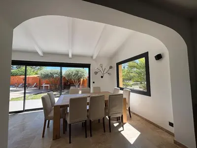 a dining room with a table and chairs at Villa Soleil Piscine Jacuzzi Pétanque Espace bbq billard et salons extérieurs in Aix-en-Provence