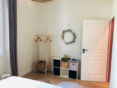 a bedroom with a white door and a mirror at Chez Anna - Centre-ville - in LʼIsle-sur-la-Sorgue