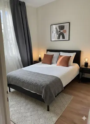 a bedroom with a bed with brown pillows at Le petit cardeur in Aix-en-Provence