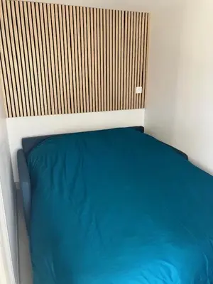 a blue couch with colorful pillows on it at Appartement en Luberon in Pertuis