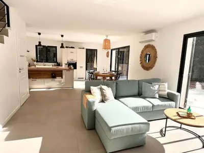 a living room with a couch and a table at Villa Mimosa in Venasque