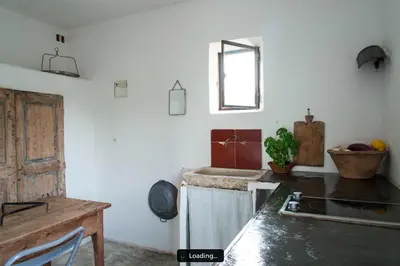 a kitchen with a sink and a stove top oven at Le cabanon in Vaugines