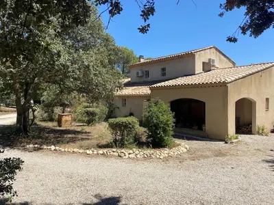 a building with a garage in front of it at Le bois des chênes in Peypin-dʼAigues
