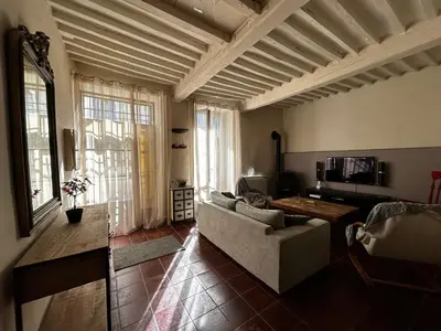 a living room with a couch and a table at Maison robion in Robion en Luberon