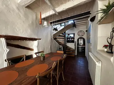 a dining room with a wooden table and chairs at Maison robion in Robion en Luberon