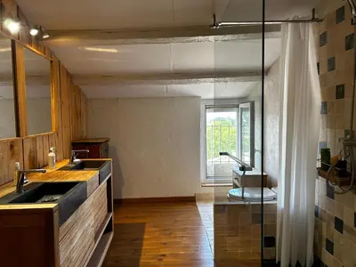 a kitchen with a sink and a glass shower at Maison robion in Robion en Luberon