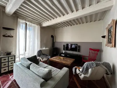 a living room with a couch and a table at Maison robion in Robion en Luberon