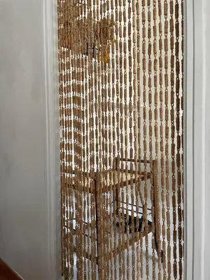 a curtain on a door with a chair at Maison Loucacia in Mormoiron