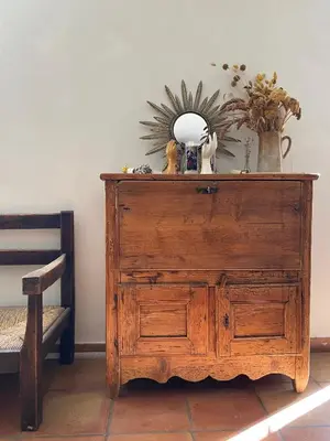 a wooden dresser with a mirror on top of it at Maison Loucacia in Mormoiron