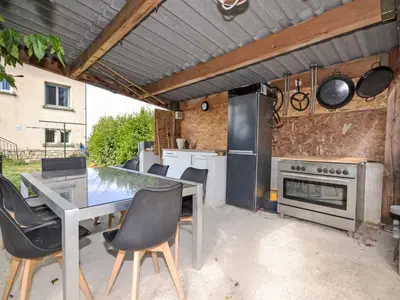 an outdoor kitchen with a table and a stove at Apartment Les Santons by Interhome in Peypin-dʼAigues