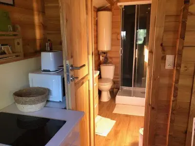 a bathroom with a toilet and a glass door at chalet le domaine des cigales in Cavaillon