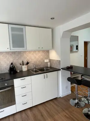 a kitchen with white cabinets and a sink at Charmant Mazet en campagne provencale in Châteaurenard