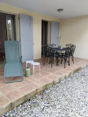 a patio with black furniture and a table and chairs at Golf de saumane in Saumane-de-Vaucluse