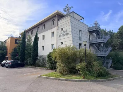 a building with a parking lot in front of it at Le Clos d'AIX studio 1 in Aix-en-Provence