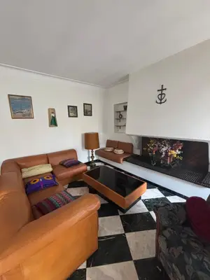 a living room with a couch and a fireplace at Maison Provençale au centre du village in Mollégès