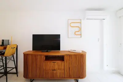 a flat screen tv sitting on top of a wooden entertainment center at Le Nid du Pradon in Cavaillon