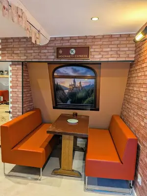 a room with a table and chairs and a tv at Le Repaire du Sorcier in Caumont-sur-Durance