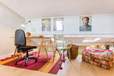 a living room with a desk and a chair at Urban loft with terrace downtown in Aix-en-Provence