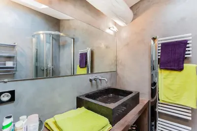 a bathroom with a sink and a mirror at Urban loft with terrace downtown in Aix-en-Provence