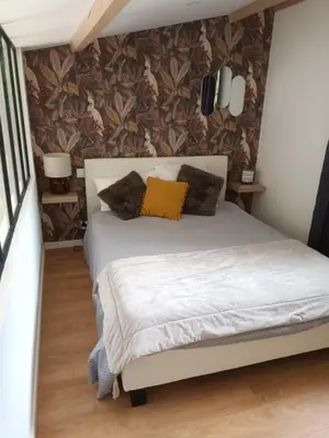 a bedroom with a white bed with pillows on it at petite Villa in Manosque
