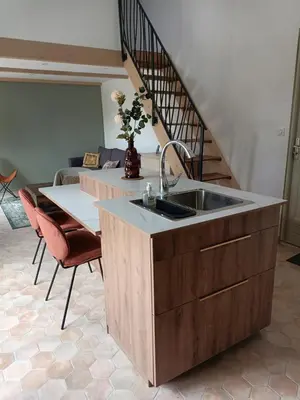 a kitchen with a sink and a table at petite Villa in Manosque