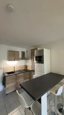 a kitchen with a black counter top and white appliances at Magnifique T2 Aix-en-Provence in Aix-en-Provence