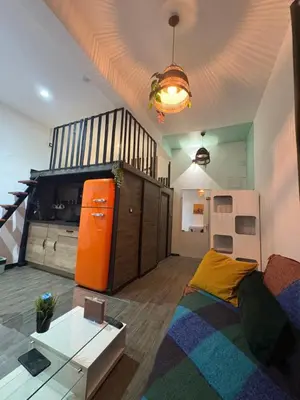 a living room with a couch and a staircase at Le Cocoon Provençal - à deux pas de la mairie tout inclus in Aix-en-Provence