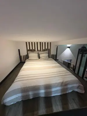 a bedroom with a large bed with white sheets at Le Cocoon Provençal - à deux pas de la mairie tout inclus in Aix-en-Provence
