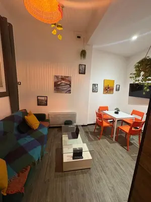 a living room with a couch and a table at Le Cocoon Provençal - à deux pas de la mairie tout inclus in Aix-en-Provence