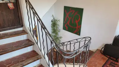 a living room with a bed and a rug at Magnifique demeure de caractère au cœur de Lacoste in Lacoste