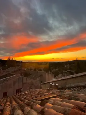a sunset over roofs of a city at sunset at L'escalier gaucher in Lambesc