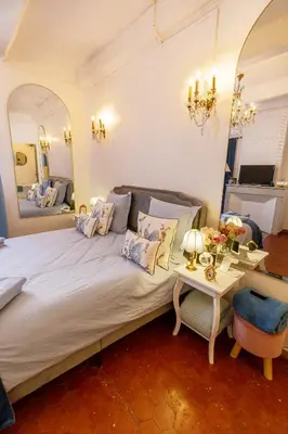 a bedroom with a large bed and a table at L'escalier gaucher in Lambesc