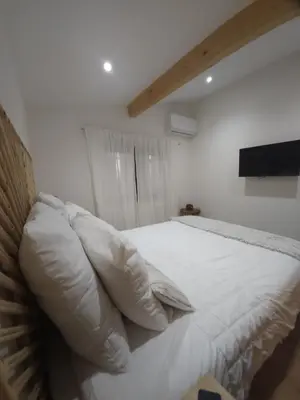 a bedroom with a bed with white sheets and pillows at Duplex Design - Clim - Parking privé - Wifi - by CommeChezSoi in Vedène