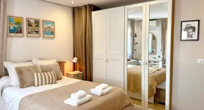 a bedroom with two beds and a mirror at Modern Villa With Views Of Gordes in Gordes