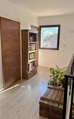 a living room with a door and a book shelf at Modern Villa With Views Of Gordes in Gordes