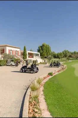 two golf carts are driving down a road at Appartement Pont Royal vu lac in Mallemort