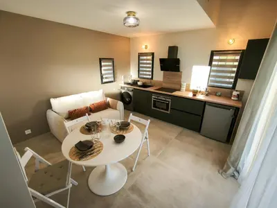 a living room with a white table and a couch at Le Mazet de Christol in Eygalières