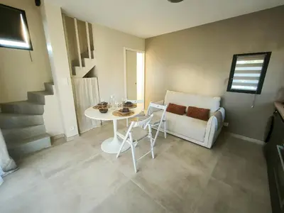 a living room with a table and a couch at Le Mazet de Christol in Eygalières