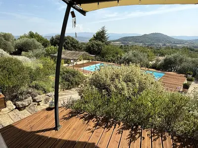 a view from the deck of a villa with a swimming pool at Le mas Donalia in Saint-Saturnin-les-Apt