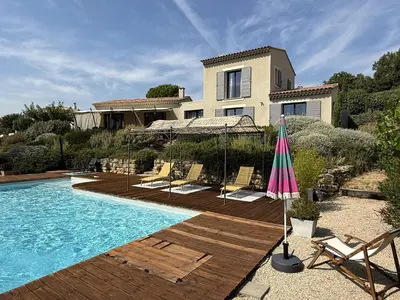 a villa with a swimming pool and a house at Le mas Donalia in Saint-Saturnin-les-Apt