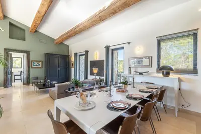 a dining room with a white table and chairs at Madame Luberon in Roussillon