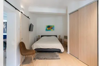 a bedroom with a bed and a chair in it at Sweet Home in Aix-en-Provence