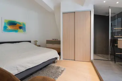 a bedroom with a bed and a sliding glass door at Sweet Home in Aix-en-Provence