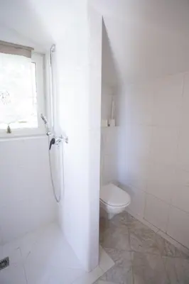 a white bathroom with a shower and a toilet at Maison Pertuis Provence in Pertuis