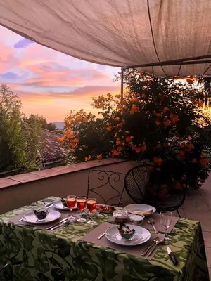 a table with glasses of wine on a balcony at Maison Pertuis Provence in Pertuis